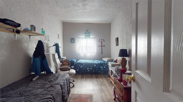 bedroom with hardwood / wood-style flooring