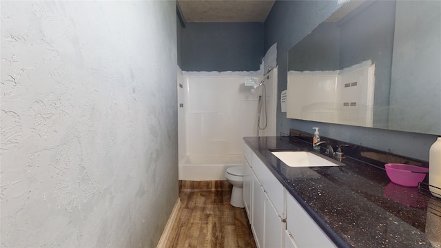 full bathroom featuring shower / bathing tub combination, toilet, hardwood / wood-style floors, and vanity