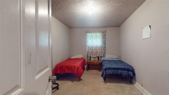 carpeted bedroom featuring a textured ceiling