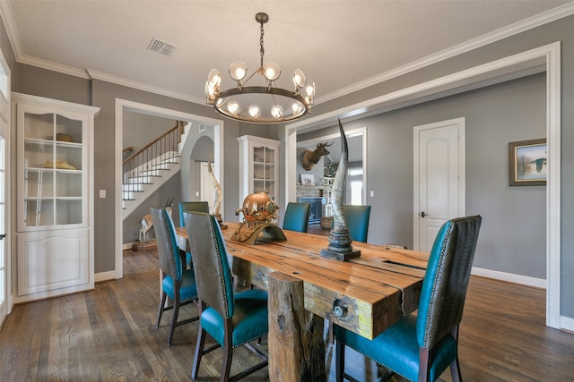 dining area with ornamental molding, an inviting chandelier, and dark hardwood / wood-style flooring