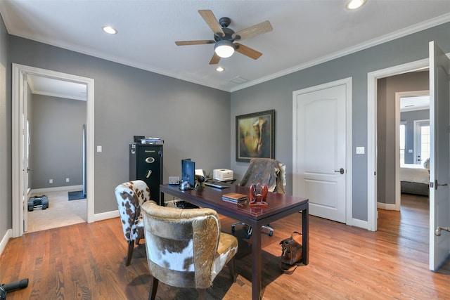 office space featuring light hardwood / wood-style floors, ornamental molding, and ceiling fan