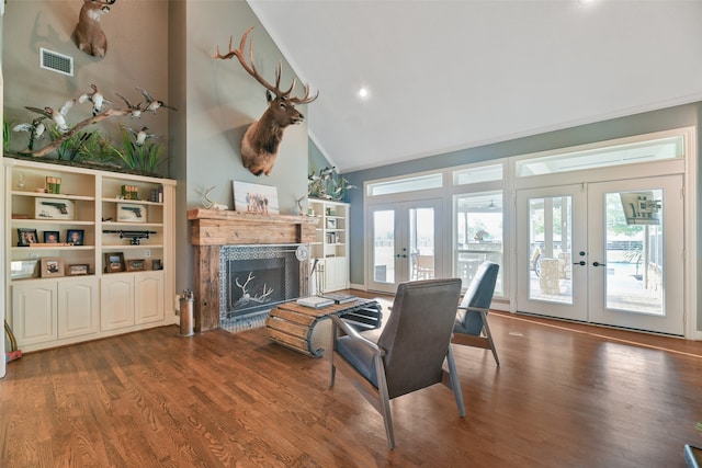 living room featuring dark hardwood / wood-style floors, high vaulted ceiling, and french doors