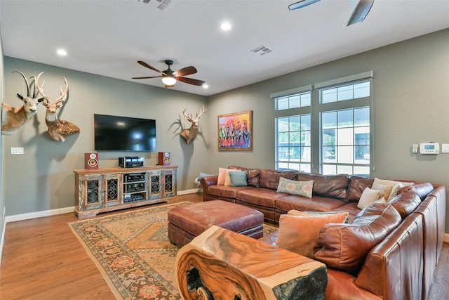 living room with ceiling fan and hardwood / wood-style flooring