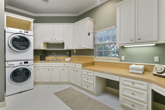 washroom with stacked washing maching and dryer, cabinets, sink, and ornamental molding