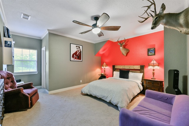 carpeted bedroom with a textured ceiling, ceiling fan, and crown molding