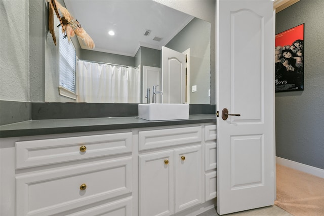 bathroom with crown molding and vanity