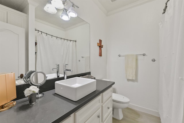 bathroom featuring wood-type flooring, ornamental molding, toilet, and large vanity