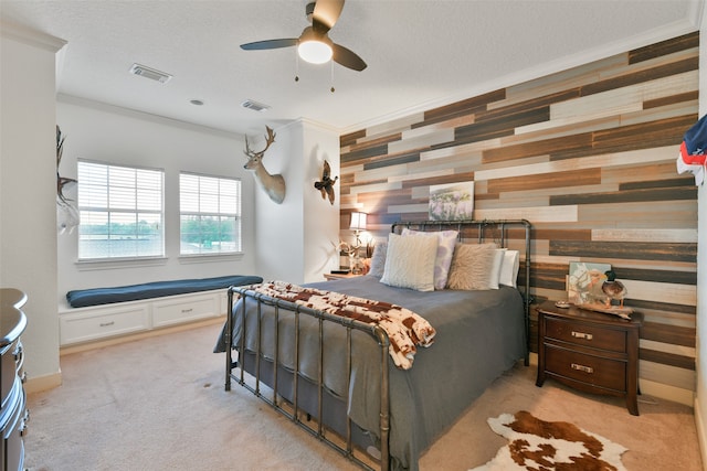 carpeted bedroom featuring a textured ceiling, ceiling fan, and crown molding