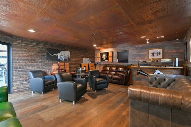 living room featuring wood ceiling, hardwood / wood-style flooring, brick wall, and wooden walls