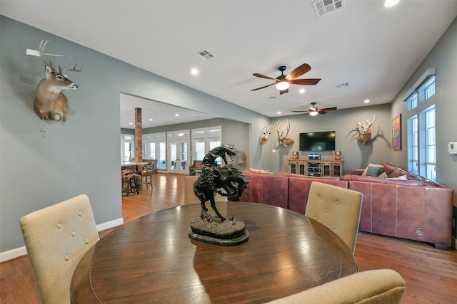 dining area with ceiling fan, french doors, and wood-type flooring