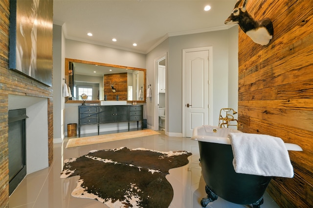 bathroom with tile floors, a fireplace, crown molding, and vanity