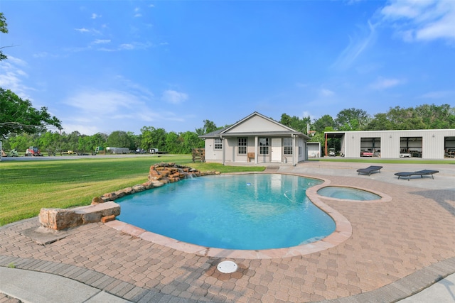 view of pool with an in ground hot tub and a lawn