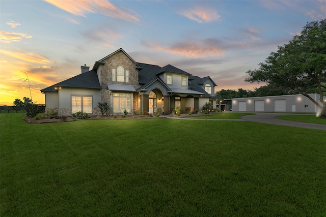 view of front of home featuring a garage and a yard