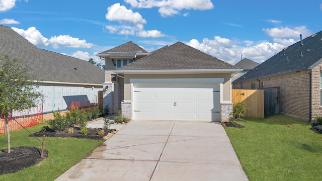 view of front facade featuring a garage and a front lawn