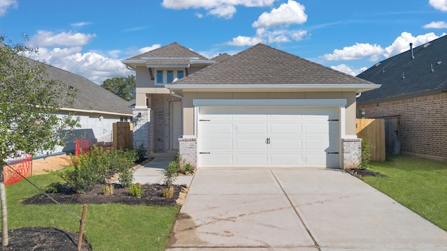 view of front of property featuring a front lawn and a garage