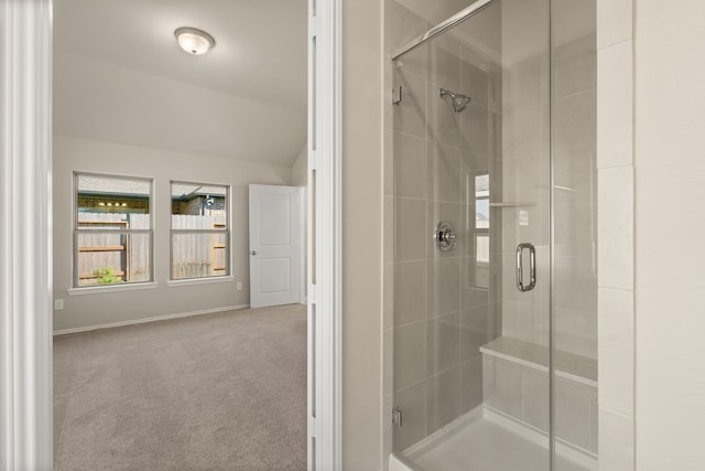 bathroom with lofted ceiling and a shower with shower door