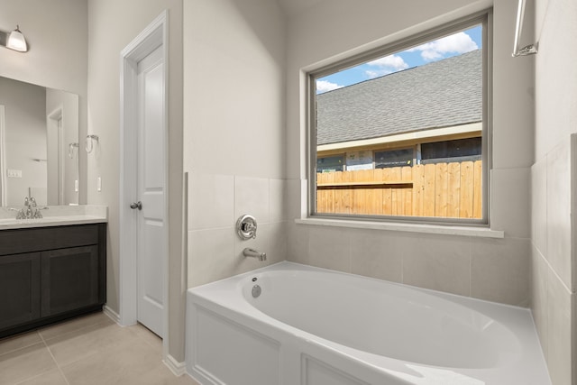 bathroom with vanity, tile patterned flooring, and a washtub