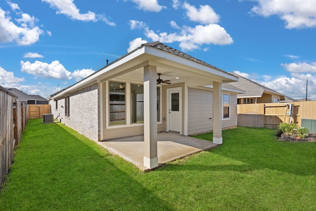 back of house with cooling unit, ceiling fan, a lawn, and a patio area