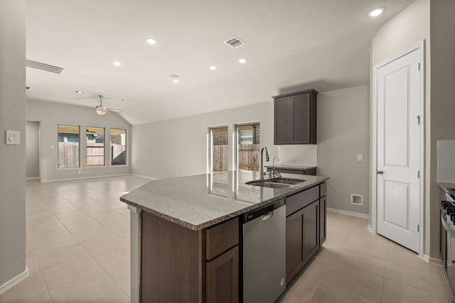 kitchen with an island with sink, lofted ceiling, sink, dark brown cabinets, and appliances with stainless steel finishes