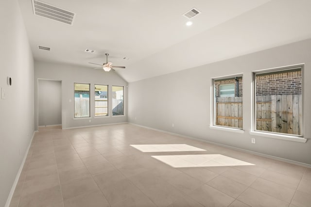 tiled empty room featuring ceiling fan and vaulted ceiling