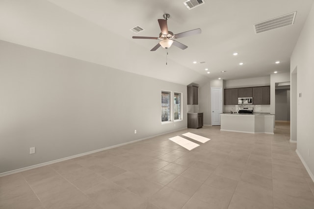 unfurnished living room featuring ceiling fan, lofted ceiling, and light tile patterned floors