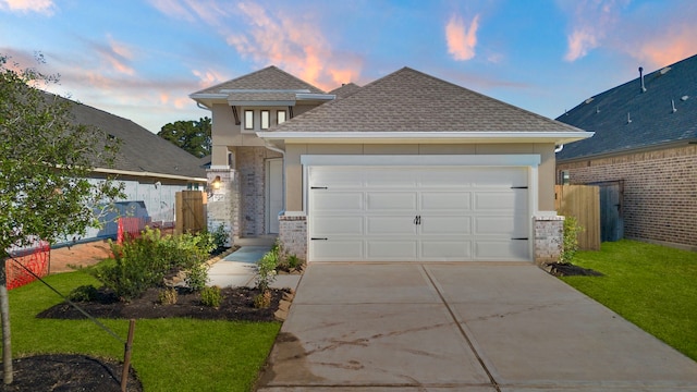 view of front facade featuring a garage and a lawn