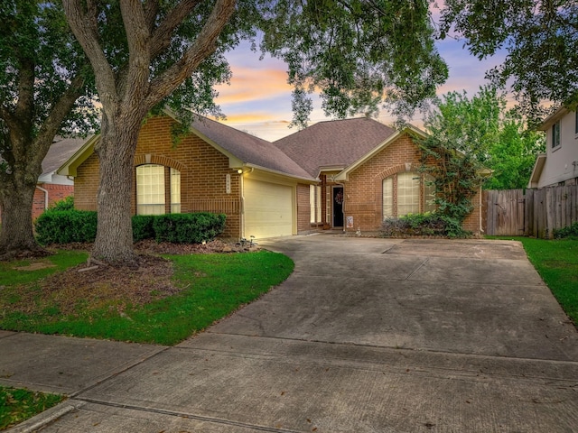 ranch-style home featuring fence, roof with shingles, concrete driveway, a garage, and brick siding