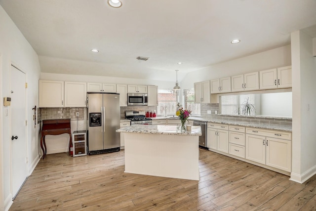 kitchen featuring visible vents, decorative backsplash, appliances with stainless steel finishes, and light wood finished floors