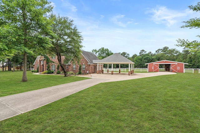 view of front of house featuring a gazebo, a front lawn, and an outdoor structure