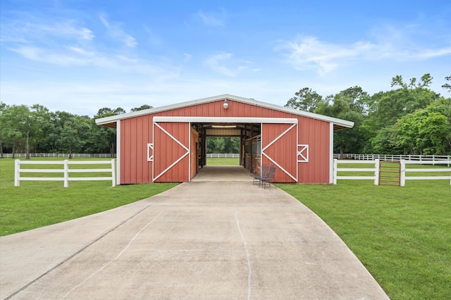 view of outdoor structure featuring a rural view and a lawn