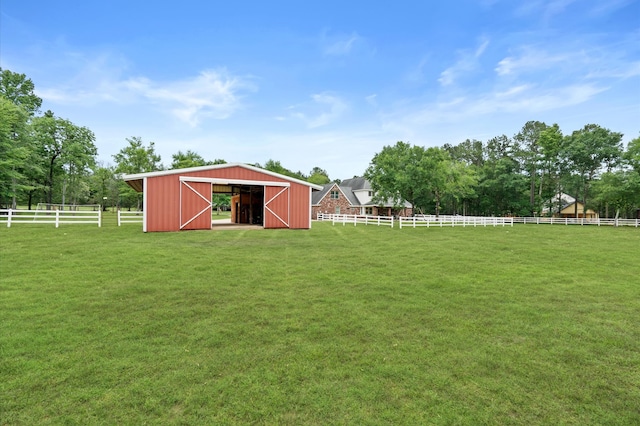 view of yard featuring a rural view and an outdoor structure