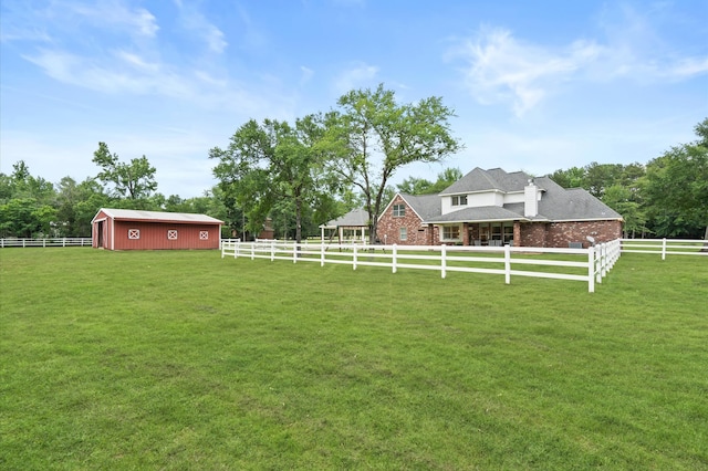 view of yard featuring an outbuilding and a rural view