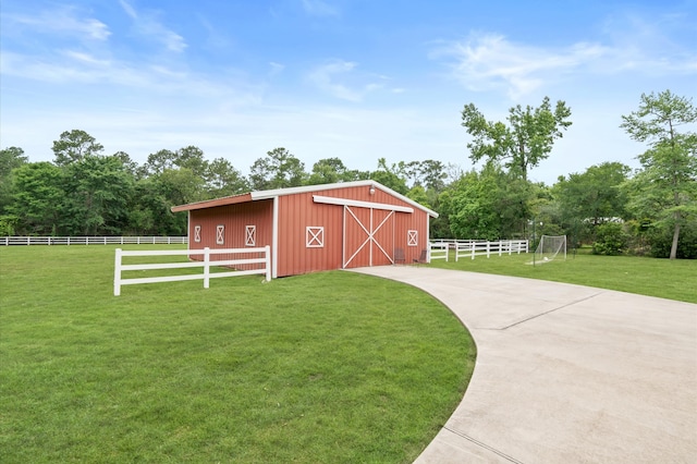 view of outdoor structure featuring a yard and a rural view