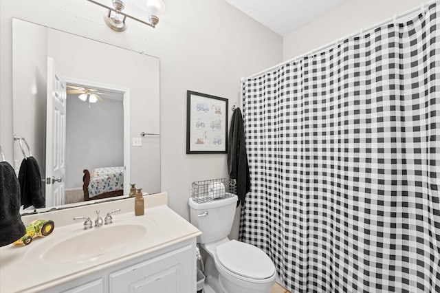 bathroom with vanity, toilet, and ceiling fan