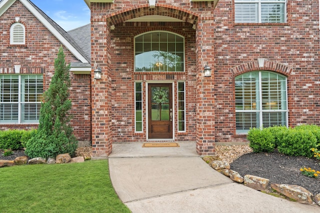 doorway to property featuring a lawn