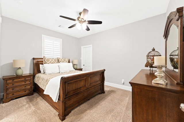 bedroom with ceiling fan and light carpet