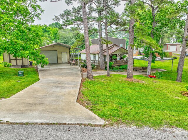 view of front facade with a garage, an outbuilding, and a front lawn