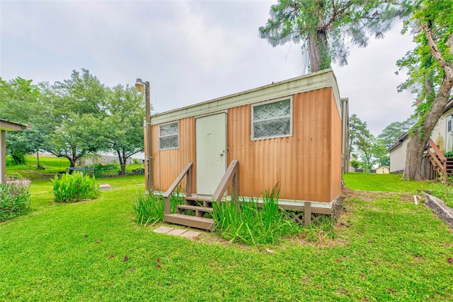 view of outbuilding featuring a yard