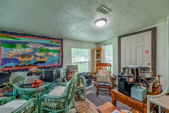 carpeted office space with a textured ceiling