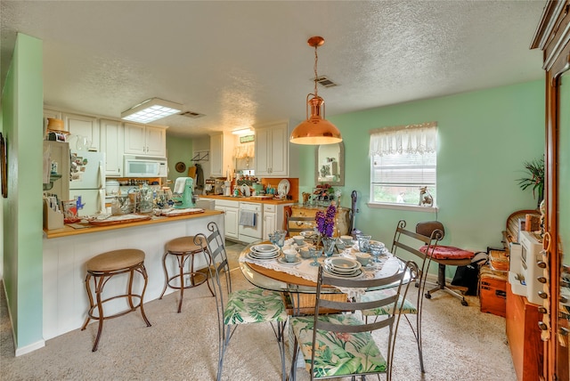 dining space with a textured ceiling