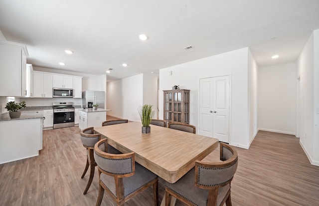 dining area with light hardwood / wood-style floors