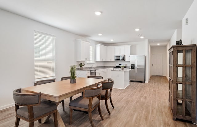 dining space with light wood-type flooring