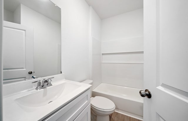 full bathroom with wood-type flooring, vanity, toilet, and washtub / shower combination