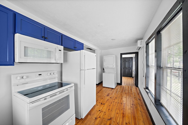 kitchen with white appliances, a wall mounted AC, light wood-type flooring, and blue cabinets