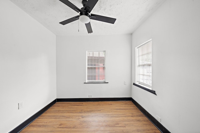 unfurnished room featuring a textured ceiling, ceiling fan, and light hardwood / wood-style flooring