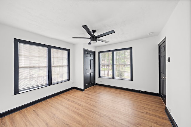 spare room featuring ceiling fan and light hardwood / wood-style floors