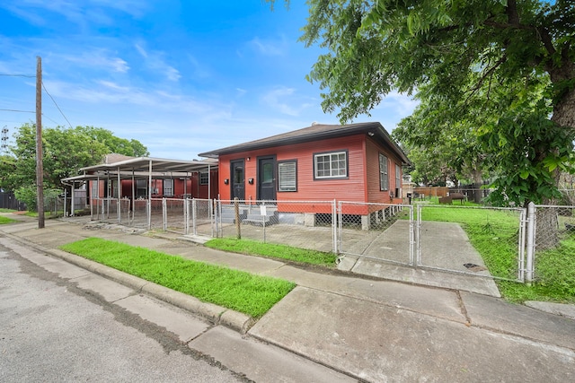 view of front facade with a front yard and a carport