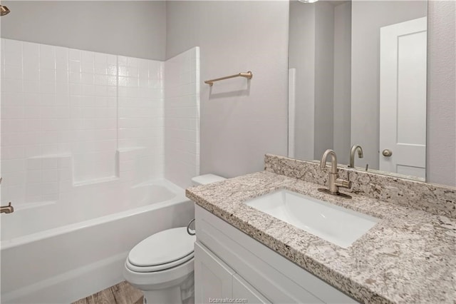 full bathroom featuring tub / shower combination, wood-type flooring, vanity, and toilet