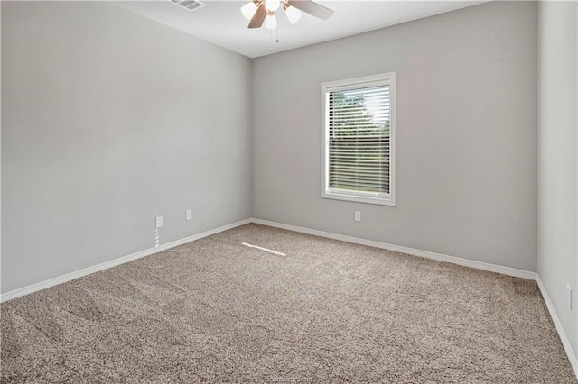 carpeted spare room featuring ceiling fan