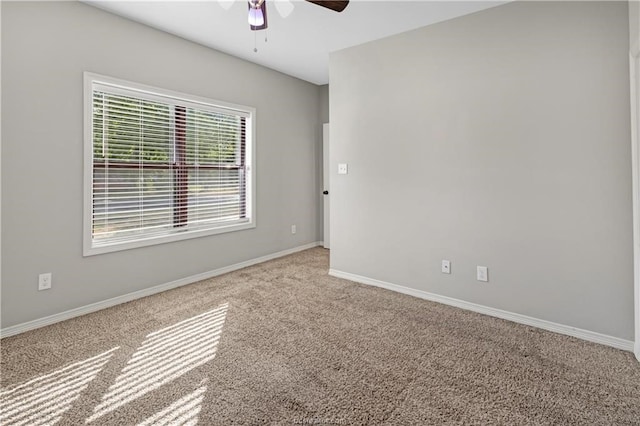 carpeted spare room featuring ceiling fan